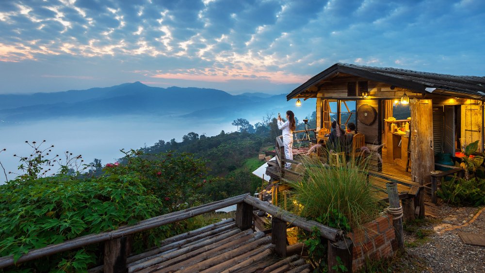 woman-taking-photo-morning-mist-phu-lang-ka-phayao-thailand